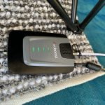 Weboost amplifier on campsite rug for cellular service boost at campsite.