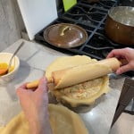 Place the pie dough using a rolling pin for the pot pie.