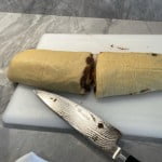 Cutting cinnamon rolls with a sharp knife.