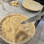 Cut vents and paint on egg wash to the top dough of the chicken pot pie.