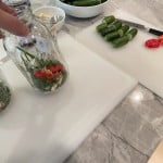 Add heat to the garlic dill pickle recipe with peppers; banana peppers for milder pickles and habanero, serrano or jalapeño peppers for more heat.