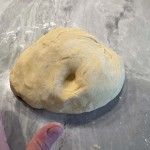 Smooth cinnamon roll dough should be elastic and spring back when poked with a finger.