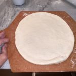 Stretched pizza dough ready for toppings and the oven.