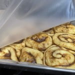 Cinnamon rolls in a baking pan after rising for 1 - 2 hours at room temperature.