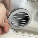 Slide the grill into the air duct rough opening.