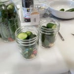 Cut shorter sections of whole cucumbers for smaller canning jars.