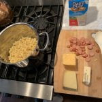 Begin mac and cheese by slilghtly under cooking the pasta you plan to use.