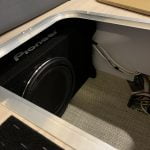 Placing the new subwoofer under the dinette in the Airstream Globetrotter.