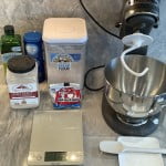 Home made pizza dough recipe ingredients - bread flour, yeast, salt, olive oil and water. Stand mixer is helpful but not necessary. A bakers scale makes the job easier.