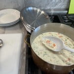 Simmer chicken white sauce (Béchamel) filling for pot pie and allow to thicken.