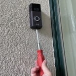 Carefully loosen the bottom mounting screw on the Ring Doorbell.