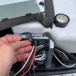 Pass the EasyStart wires through the AC electrical box. Wrap several turns of vinyl electrical tape around the wire bundle to protect them from sharp edges as they pass into the box.