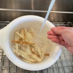 Potato slices are soaked and rinsed to remove starch.