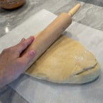 Roll out the dough to form a large rectangle of the cinnamon roll dough.
