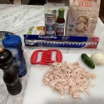 Shredded chicken breast, jalapeño, onion and red enchilada sauce for chicken nacho recipe.