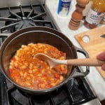 BBQ bean recipe with white cannellini beans, mustard, red bell pepper, and bacon.