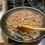 Heat until ground beef is cooked through, using wooden spoon to break up beef and mix with vegetables.