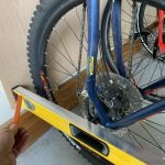 Install the bottom wheel bracket for the Steadyrack system at the level of the bottom bike wheel axle.