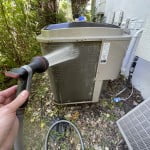 Using a gentle garden hose spray, gently rinse the condenser coils.