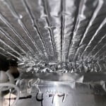 Foil bubble wrap and foil HVAC tape are used at the Airstream factory to isolate and insulate the return air plenum area between the mounted Dometic AC and the RV cabin.
