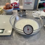 Milk and sugar mixed at warmed to 100 - 110 degree Fahrenheit to activate and proof yeast for cinnamon roll recipe. to