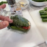 Pack the dill and garlic filled canning jars with whole cucumbers for dill pickle canning recipe.